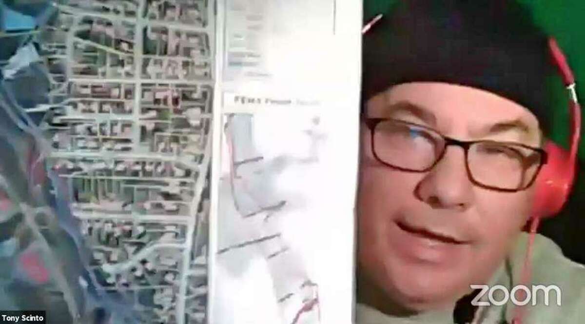 Town council member Tony Scinto holds up a flood map he says shows the Pequonnock River misleadingly close to his house during the May 9 2020 meeting of the Redistricting Committee.