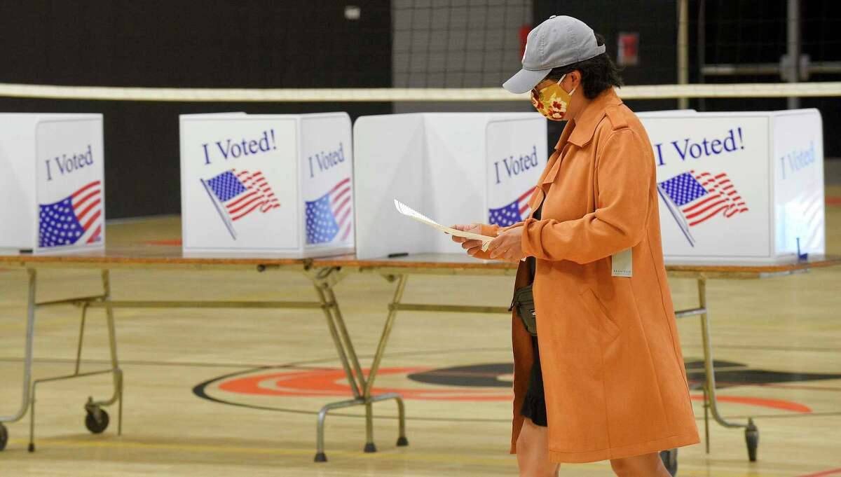 A voter checks her ballot after casting her vote in the last presidential primary prior to the November Elections, at the Polling Station for District #5 at Stamford High School on August 11, 2020 in Stamford, Connecticut.