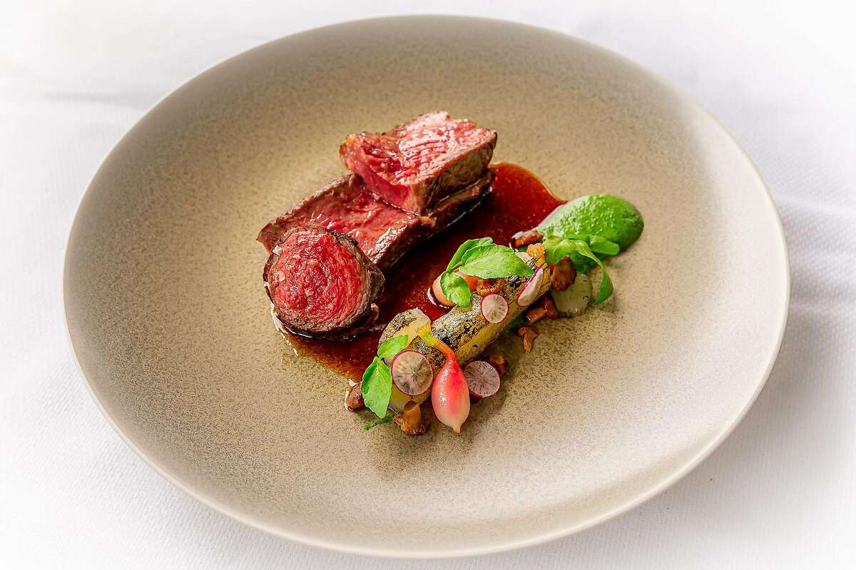 Stemple Creek Ranch beef and celtuce cooked in smoked beef fat with chanterelle mushroom and cress is served at one of San Francisco restaurant Quince's lunches at Fresh Run Farm in Marin County.