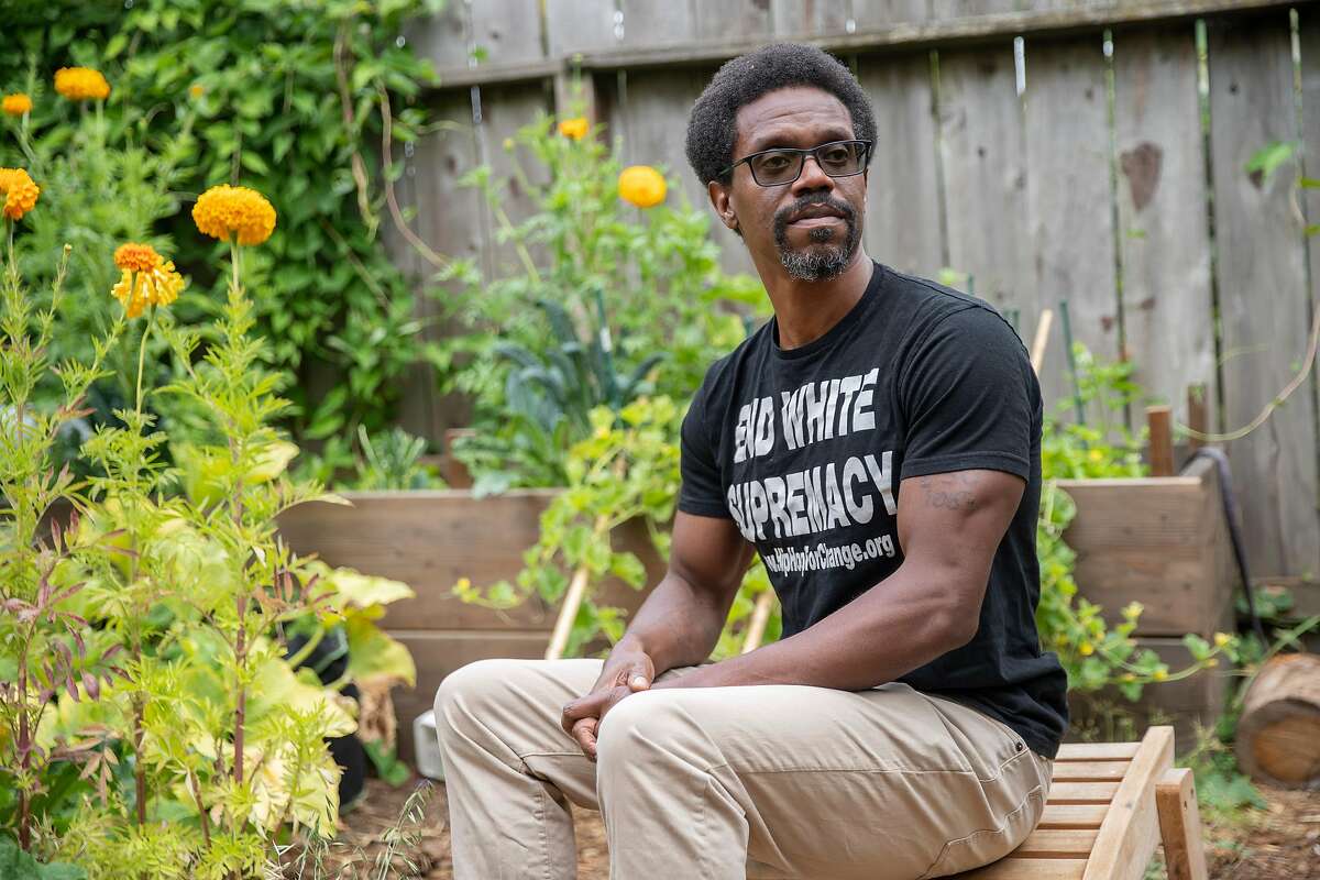 A portrait of Emile DeWeaver at his backyard on Tuesday, Aug. 4, 2020, in Oakland, Calif. DeWeaver is a community organizer, literary writer and journalist who co-founded prisonrenaissance.org. He was formerly incarcerated at San Quentin State Prison. His sentence was commuted by Gov. Jerry Brown in 2017. He went to prison as a young man, convicted of murder, and then grew up in prison, where he grappled with the traumas of his youth while avoiding prison gangs and taught himself to be a writer while spending more than 20 years behind bars.