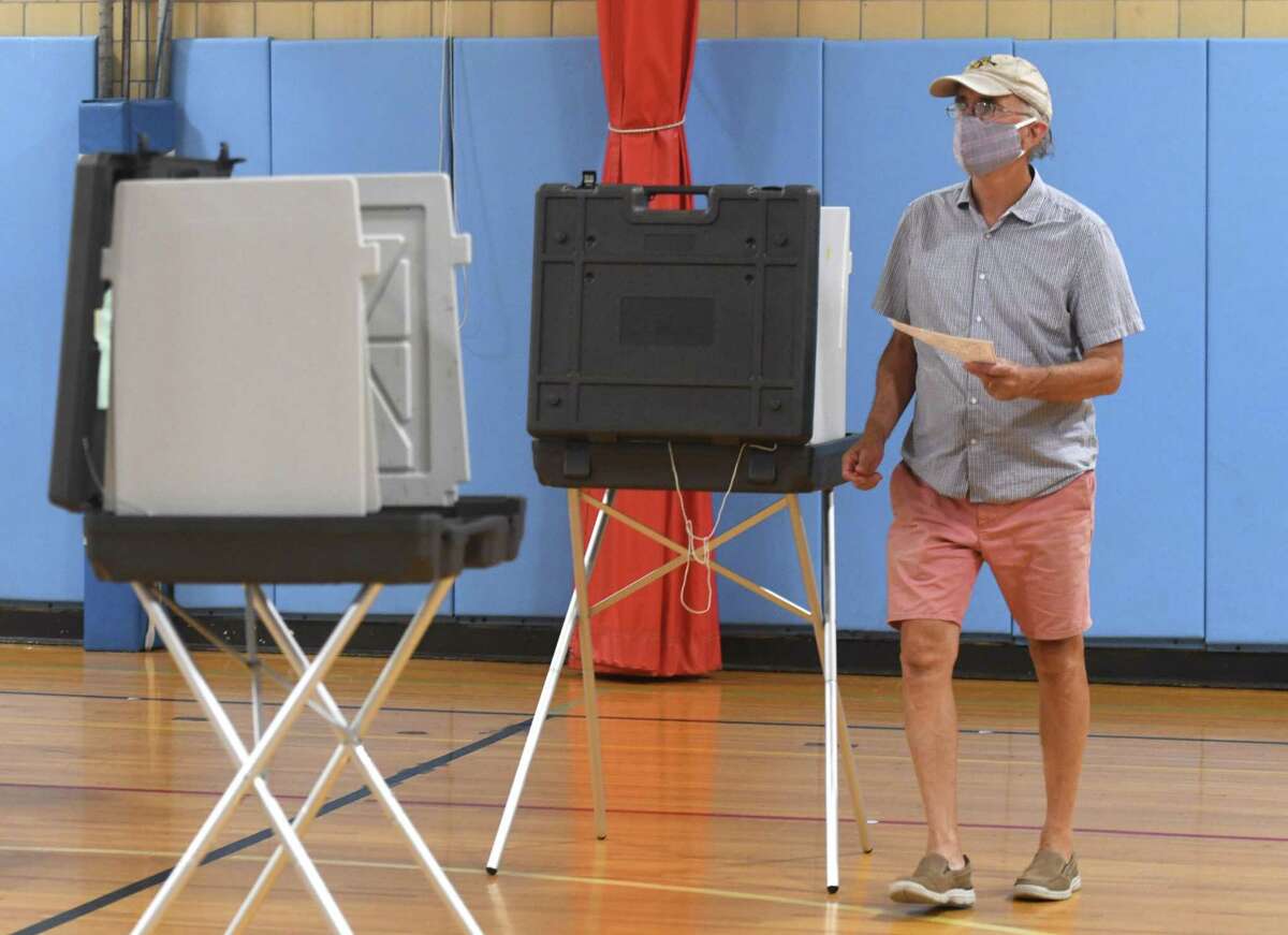 Old Greenwich's Tom Allen votes at the District 5 polling center at Old Greenwich School in Old Greenwich, Conn. Tuesday, Aug. 11, 2020. Greenwich saw a low turnout in the state's presidential primary, which took place Tuesday after being delayed since April.