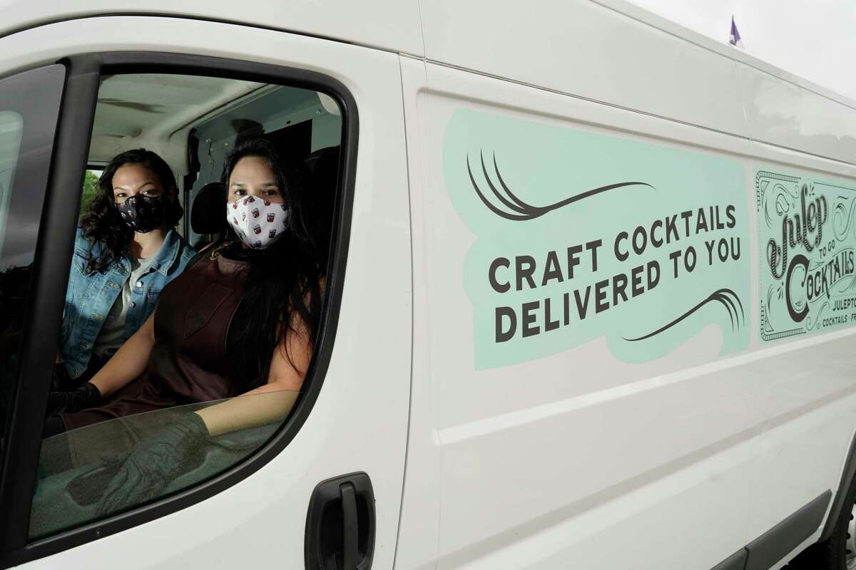 Andrea Irving, bar staff, left, with Alba Huerta, owner of Julep, 1919 Washington Ave., are shown in the cocktail delivery truck she has added to try and survive the bar shutdown amid the coronavirus pandemic shown Saturday, July 25, 2020, in Houston.
