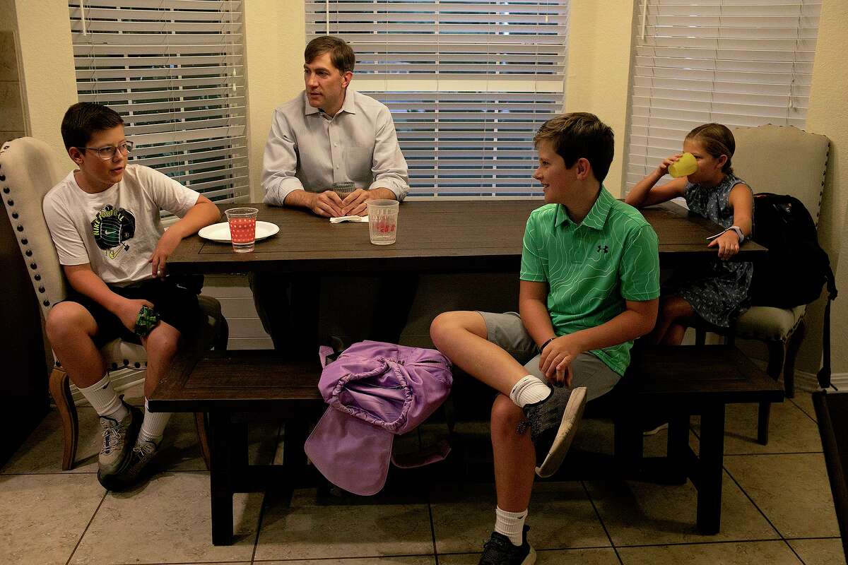 Kevin Thompson sits with his children including Cooper, 12, from left, and twins Tucker and Elizabeth, 10, as they prepare for the first day of school in Boerne on Wednesday.