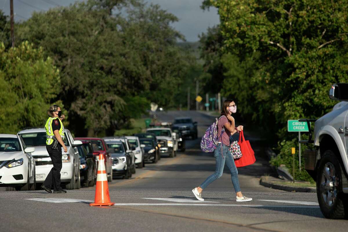 Traffic is stopped for a pedestrian crossing the street next to Boerne Middle School North on the first day of school Wednesday.