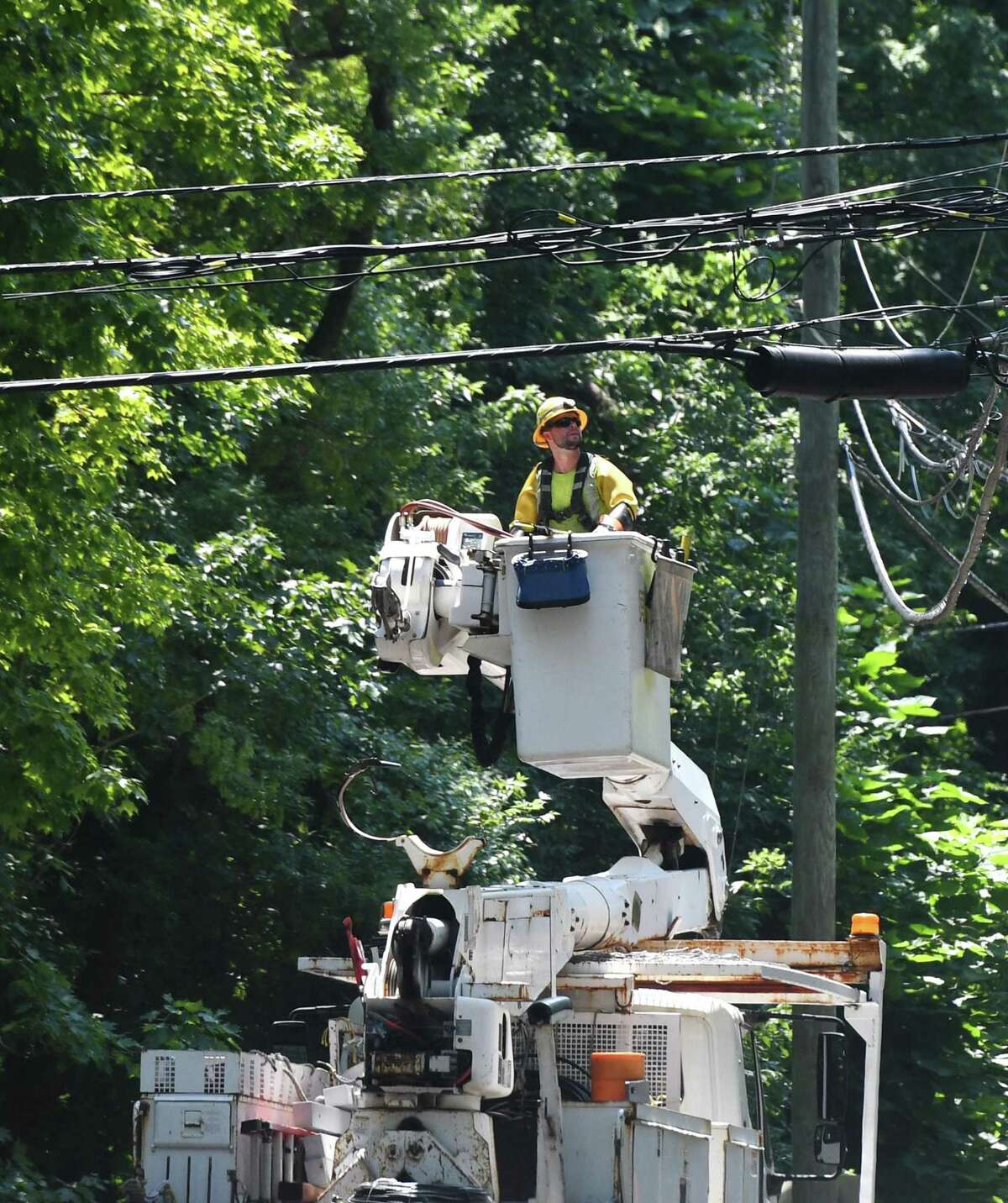 Crews repair powerlines Doubling Road six days after Tropical Storm Isaias hit Greenwich, Conn. Monday, Aug. 10, 2020. Many Eversource customers still remain without power as crews continue scrambling to repair downed powerlines and clean up fallen trees.
