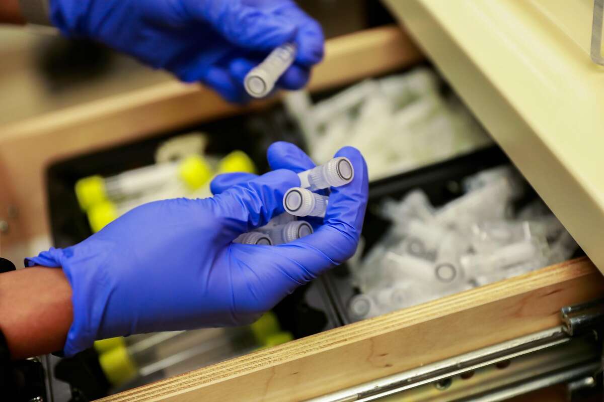 Lab coordinator Gabriella Green prepares vials to separate plasma at Bridge HIV on Wednesday, Aug. 12, 2020 in San Francisco, California.
