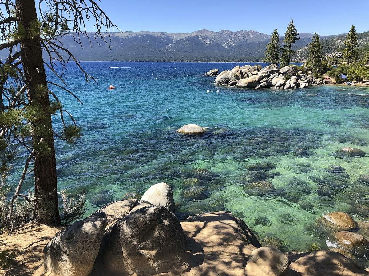 This photo taken July 13, 2020 at Lake Tahoe Nevada State Park shows a stretch of the lake's northeast shore looking north from Sand Harbor toward Incline Village, Nev. Lake Tahoe's fluctuating clarity took a dive last year, worsening by about 8 feet during an especially cold and wet winter as sedimentation, algae growth and a tiny invasive shrimp continue to pose restoration challenges. (AP Photo/Scott Sonner).