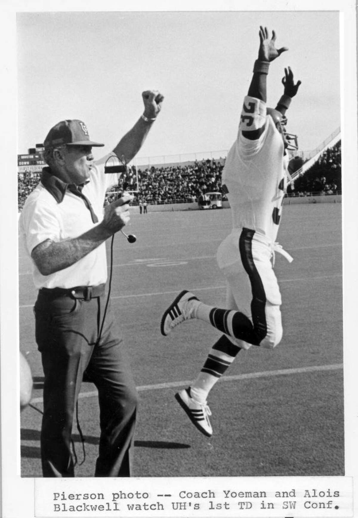 Bill Yeoman and Alois Blackwell celebrate UH's first touchdown in the Southwest Conference. The score was made with a 4-yard run by quarterback Danny Davis against the Baylor Bears in Waco in 1976.