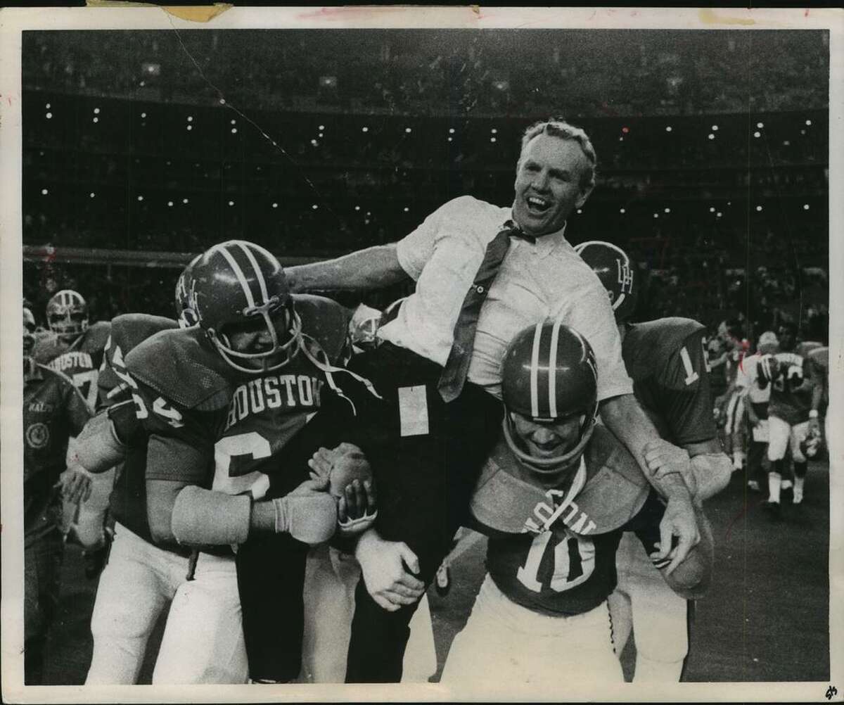 Bill Yeoman is carried off the field by UH Butch Brezina (64) and Ken Bailey (10) after beating Auburn in the 1969 Bluebonnet Bowl