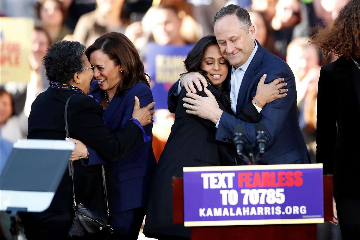 As Kamala Harris hugs a woman, her husband, Douglas Emhoff, hugs Harris' sister, Maya Harris after the California Senator launched her presidential campaign at a rally at Frank Ogawa Plaza in Oakland, Calif., on Sunday, January 27, 2019.