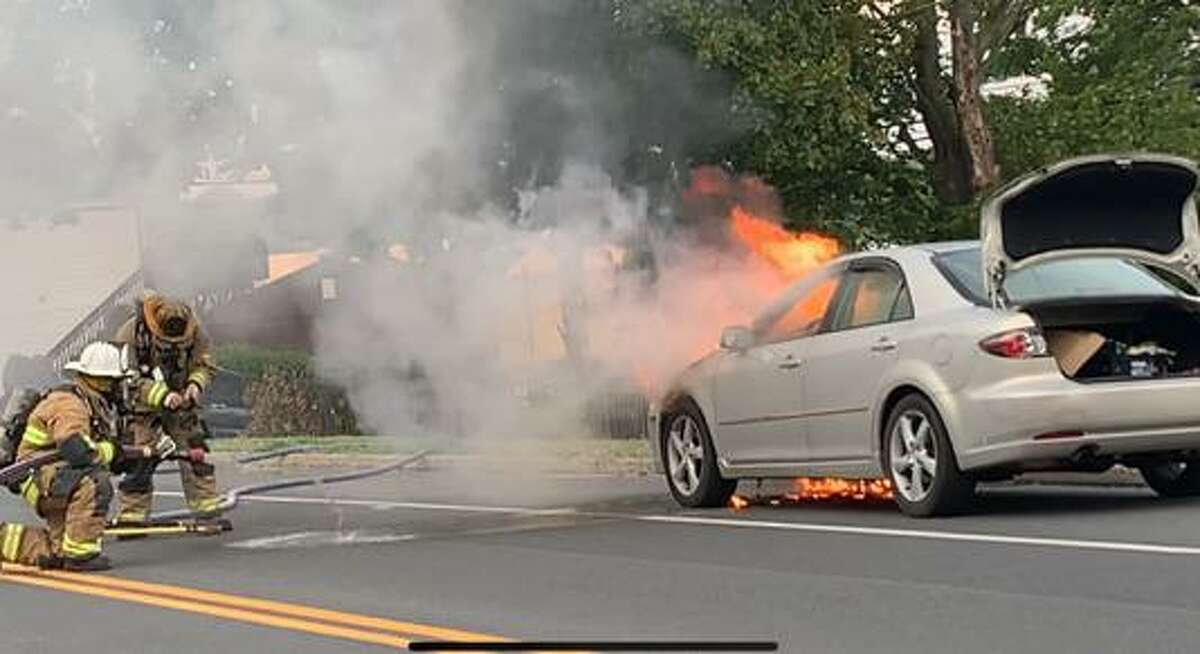 Shelton firefighters battle a car fire on River Road Wednesday, Aug. 12.