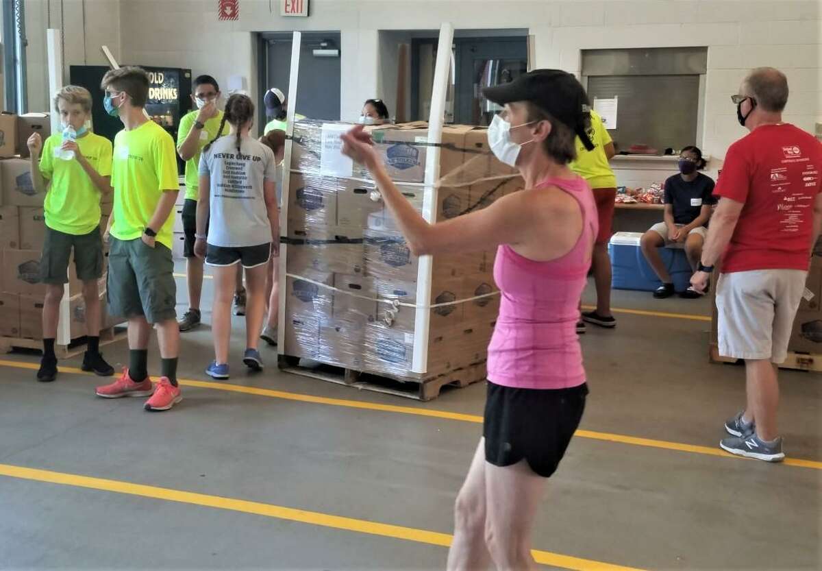 Volunteers from the Middlesex United Way and St. Vincent dePaul Middletown’s Amazing Grace Food Pantry helped unload a truck containing 1,400 20-pound boxes of fresh vegetables and fruit in Cromwell recently.
