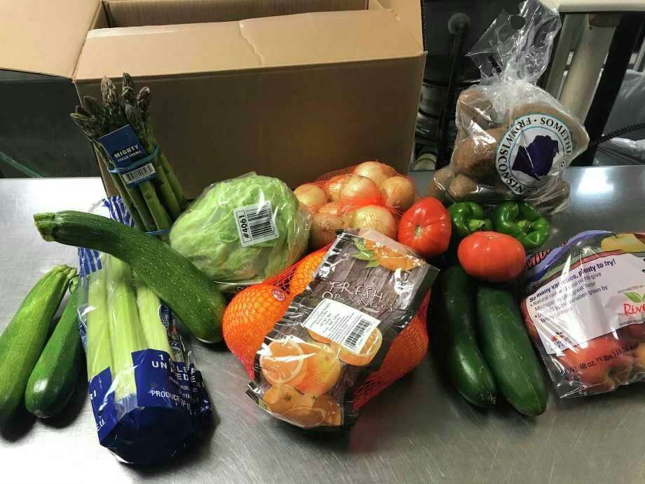 Fresh food prepared to be given out through Laker School's food distribution program. The program will continue through the upcoming school year, as school district's across Huron County plan on making changes to how students gets school meals safely. (Tribune File Photo)