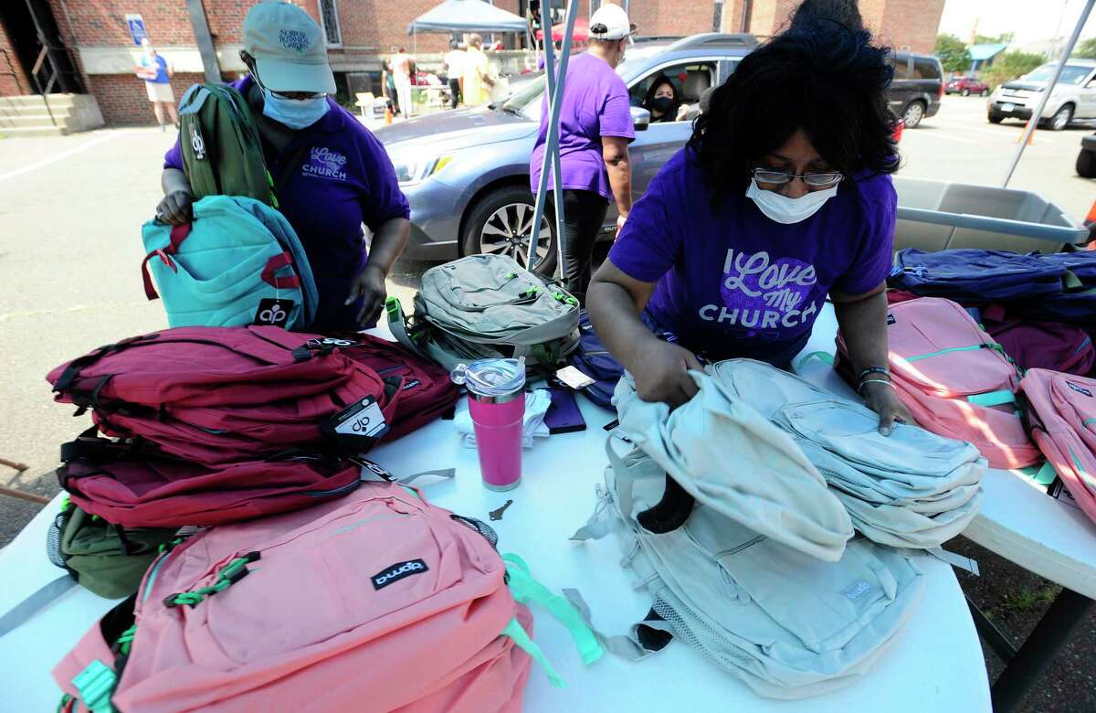 Volunteers sort and distribute new backpacks to families during a Back-to-School event hosted at the Bethel AME Church on Saturday, August 8, 2020 in Stamford, Connecticut. School children of all ages (Pre-K thru High School) were able to pick up 1 of 500 plus back packs filled with school supplies, such as pencils, crayons, paper, journals as they prepare to return to school in the fall. Stamford Public Schools announced last week plans for a Hybrid Learning, where students will receive two days of in classroom instruction and three days of continued Virtual Distance Learning, in an effort to continue the fight against the spread of Covid-19.