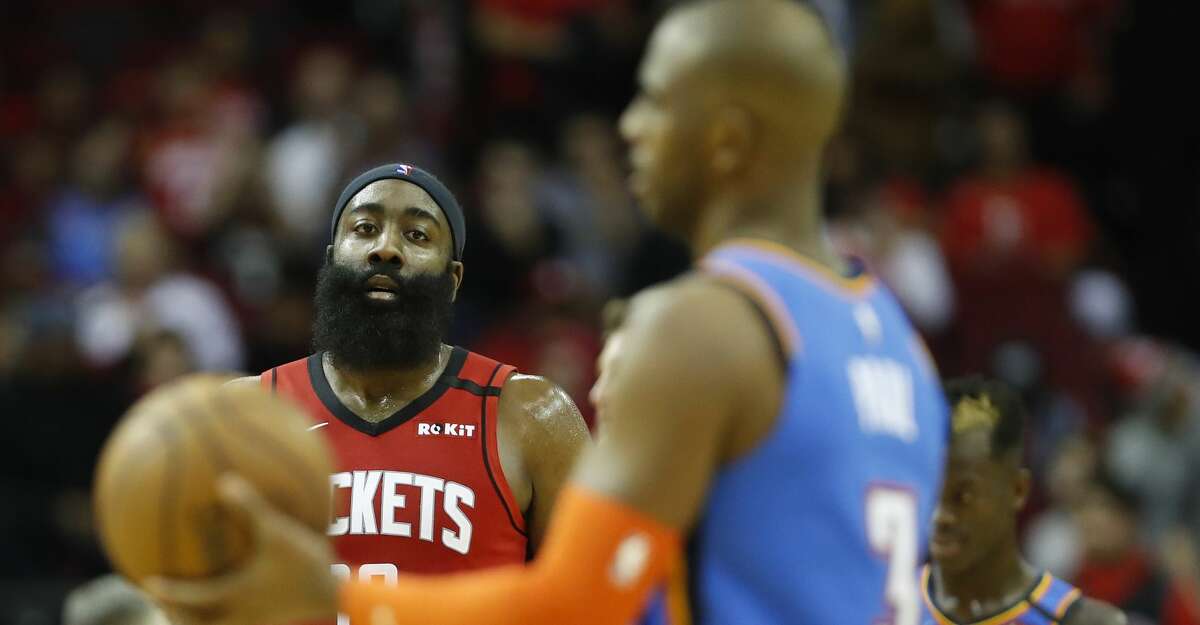 Houston Rockets guard James Harden (13) looks at Oklahoma City Thunder guard Chris Paul (3) in the final seconds of the second half of an NBA basketball game at Toyota Center, in Houston, Monday, Jan. 20, 2020.