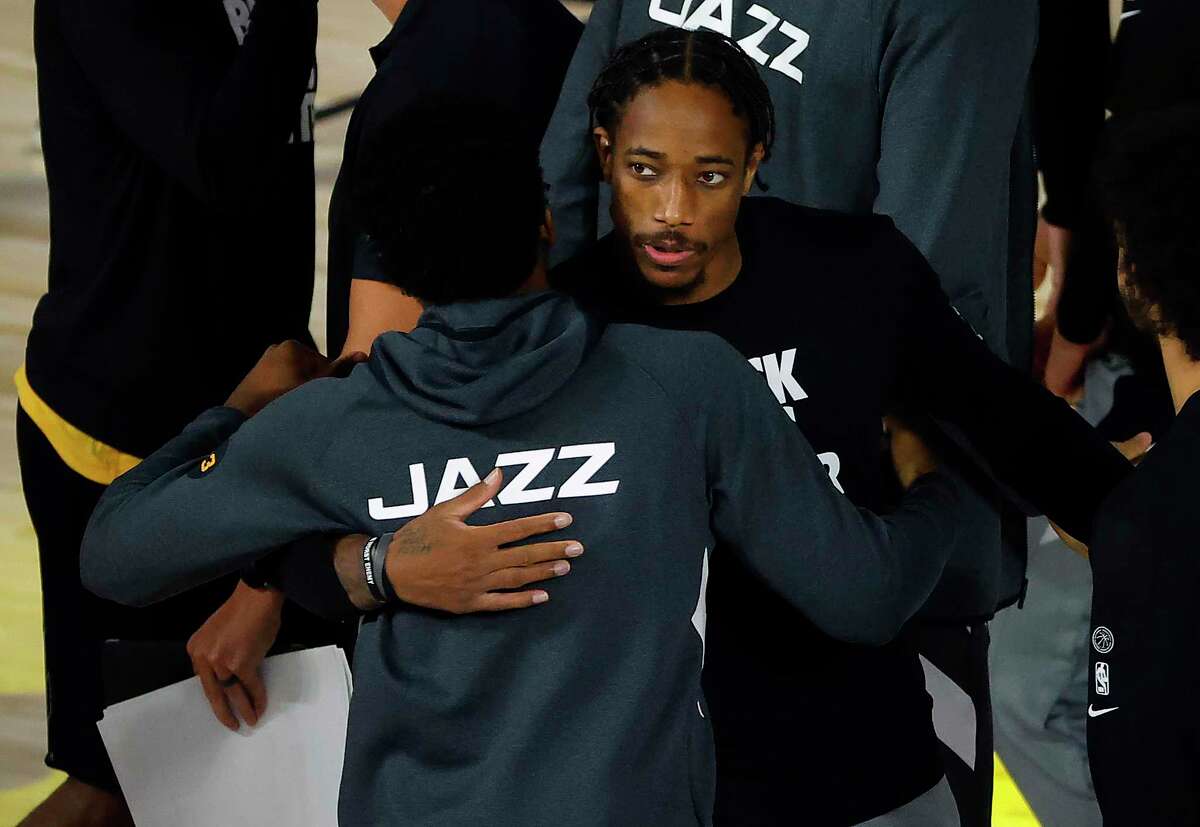 LAKE BUENA VISTA, FLORIDA - AUGUST 13: Donovan Mitchell #45 of the Utah Jazz and DeMar DeRozan #10 of the San Antonio Spurs congratulate each other after the game at The Field House at ESPN Wide World Of Sports Complex on August 13, 2020 in Lake Buena Vista, Florida. NOTE TO USER: User expressly acknowledges and agrees that, by downloading and or using this photograph, User is consenting to the terms and conditions of the Getty Images License Agreement. (Photo by Kevin C. Cox/Getty Images)