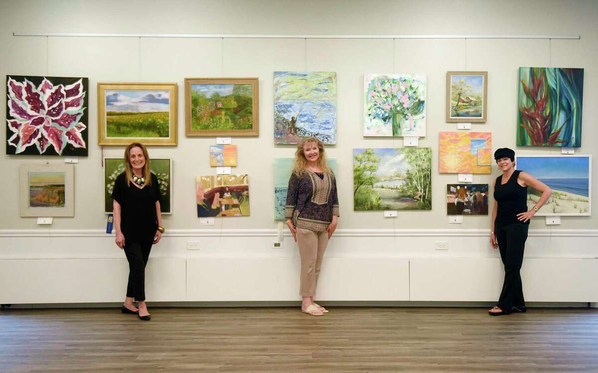 ASOG co-President Elaine Conner, left, ASOG board member and exhibit co-chair Reese Anderson Green, center, and ASOG co-President Julie DiBiase pose among work displayed in the Art Society of Old Greenwich Summer Pop-Up Exhibit at the Greenwich Botanical Center in the Cos Cob section of Greenwich, Conn. Thursday, Aug. 13, 2020. 63 pieces from 37 local artists are on display and for sale in the show, which was judged by Parsons School of Design art history professor Barbara M. Laux, Ph.D. The reception, featuring live music by Chris Fiore, will be held with mandatory masks and social distancing on Saturday, Aug. 15 at 3 p.m.