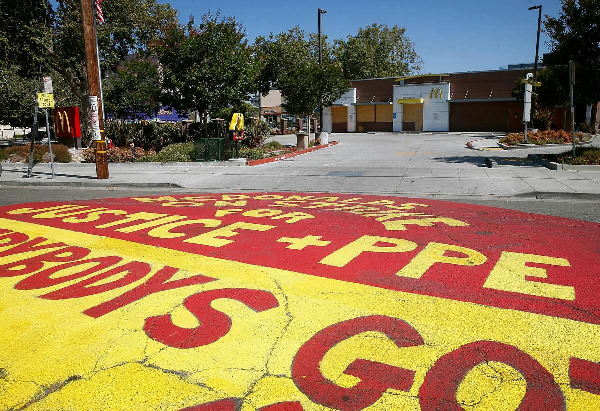 A message is painted on 45th Street in front of a shuttered McDonald's restaurant at Telegraph Avenue Oakland, Calif. on Wednesday, July 1, 2020.