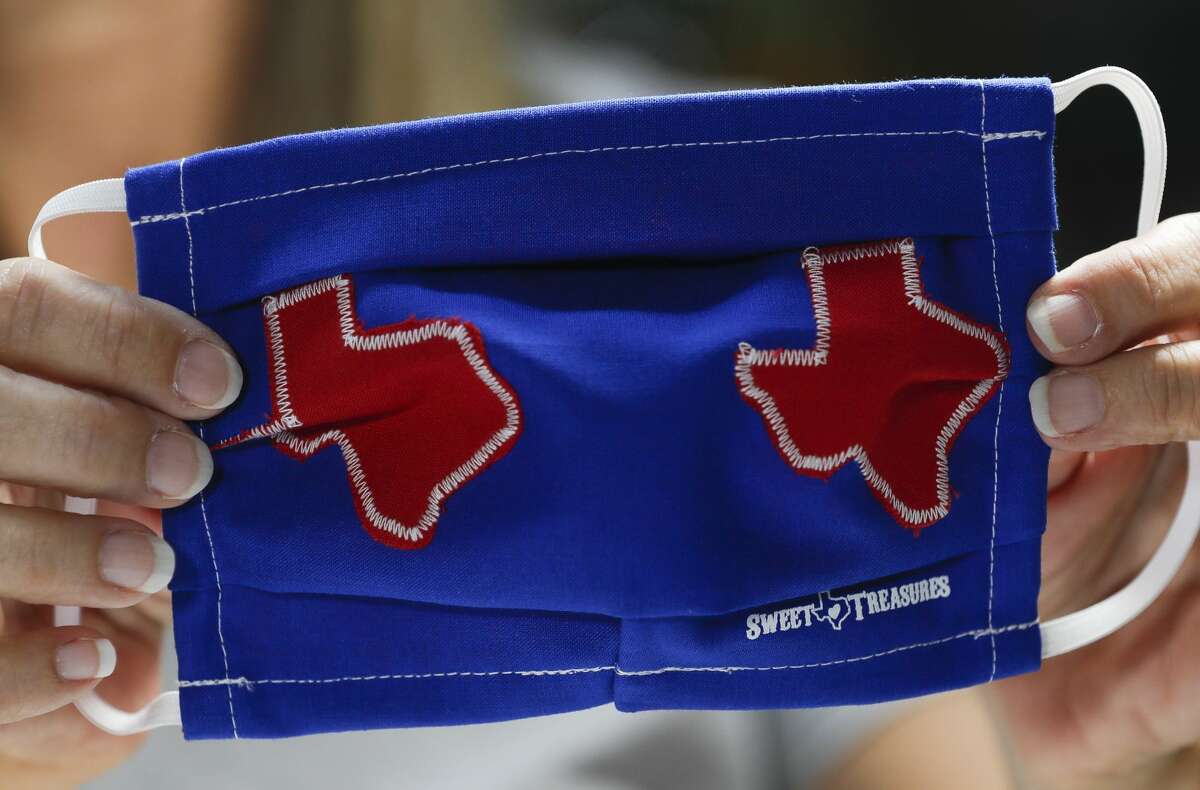 Toni Rodriguez checks the stitching on the back of a custom Texas-themed mask at Sweet Texas Treasures Boutique, Friday, July 3, 2020, in Montgomery. Gov. Greg Abbottâs statewide face-covering order, which targets Texan counties with more than 20 coronavirus cases, went into effect at noon in an effort to slow the spread of COVID-19.
