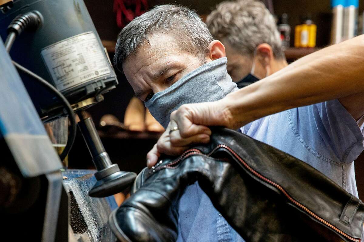 Steve Oberhauser wears a mask while working on shoes inside The Cobblery in Palo Alto, Calif. Tuesday, August 11, 2020. The current pandemic-fueled financial crisis is exacerbating existing mental health disorders for those who have them and causing anxiety and depression for many for the first time, including small business owners struggling with financial devastation. Oberhauser and his family own The Cobblery, a shoe repair shop, and has shared the toll financial devastation has taken on his mental health.