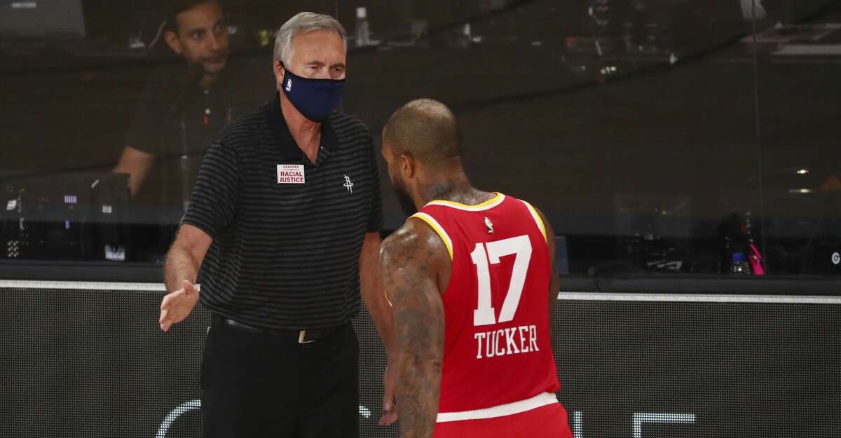 Houston Rockets head coach Mike D'Antoni greets forward P.J. Tucker (17) in the first half of an NBA basketball game Wednesday, Aug. 12, 2020, in Lake Buena Vista, Fla. (Kim Klement/Pool Photo via AP)