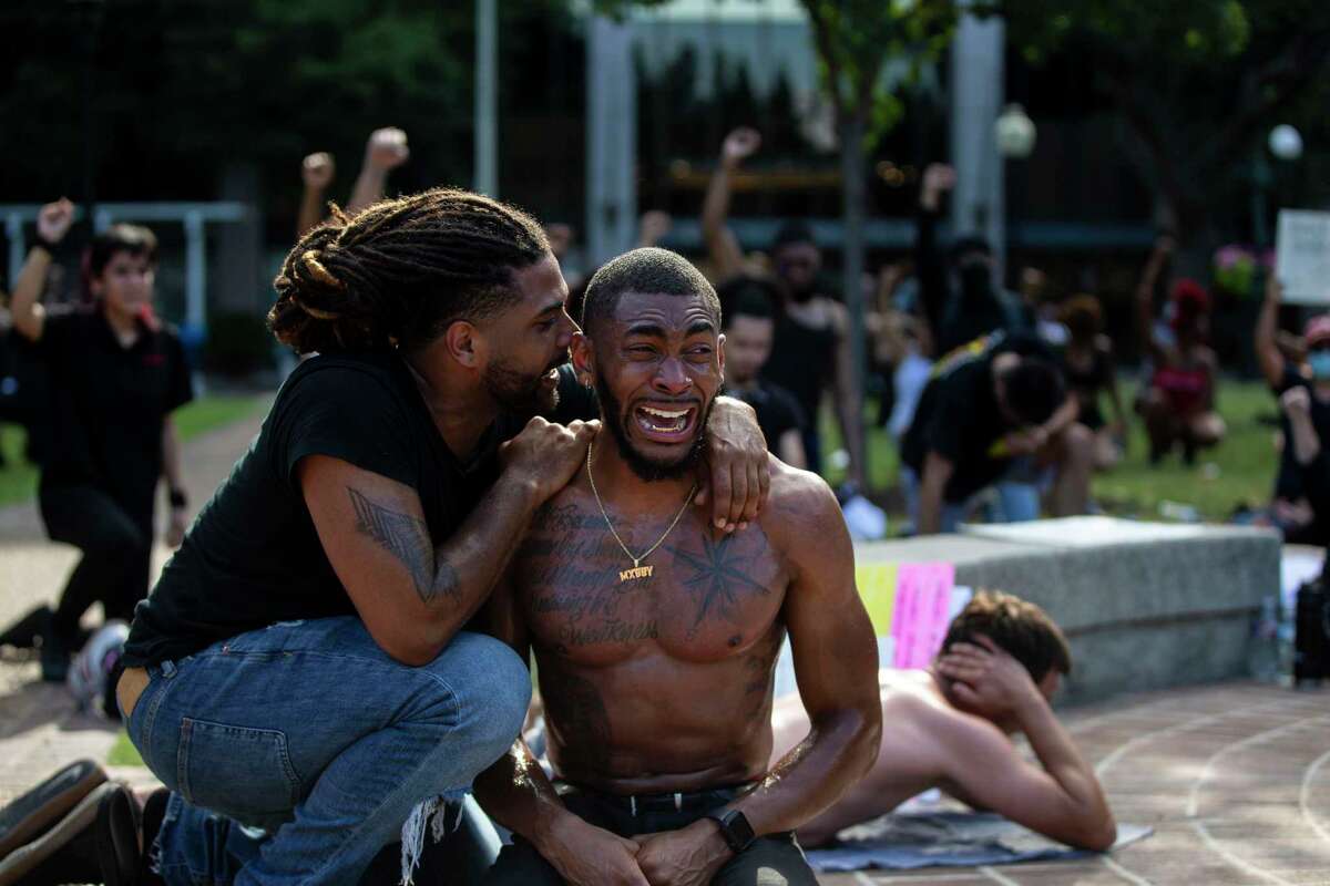 Antonio Lee comforts Trevor Taylor during an emotional moment during a demonstration at Travis Park in downtown San Antonio, Texas, on June 3, 2020. This is the fourth day of protests in San Antonio in the wake of the police killing of a black man, George Floyd, one week ago in Minneapolis.