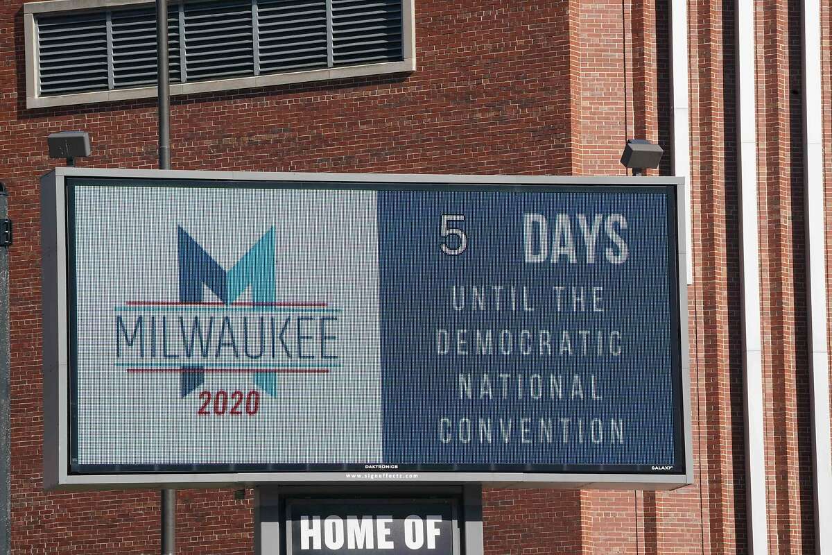 A sign advertises the convention at Wisconsin Center, home to the 2020 Democratic National Convention in Milwaukee on August 11, 2020. - Former US president Barack Obama and his wife Michelle will deliver keynote speeches during next week's Democratic National Convention when Joe Biden will be confirmed as the party's White House challenger in the November election. The Democratic Party announced on August 11, 2020 that Obama will give a primetime address next Wednesday, the convention's penultimate evening, while former first lady Michelle Obama will address the convention on Monday, opening night.The convention had been set for Milwaukee, in the battleground state of Wisconsin. But the coronavirus pandemic has upended the plans of both parties, forcing them to convert the normally raucous in-person events into online affairs. (Photo by Bryan R. Smith / AFP) (Photo by BRYAN R. SMITH/AFP via Getty Images)