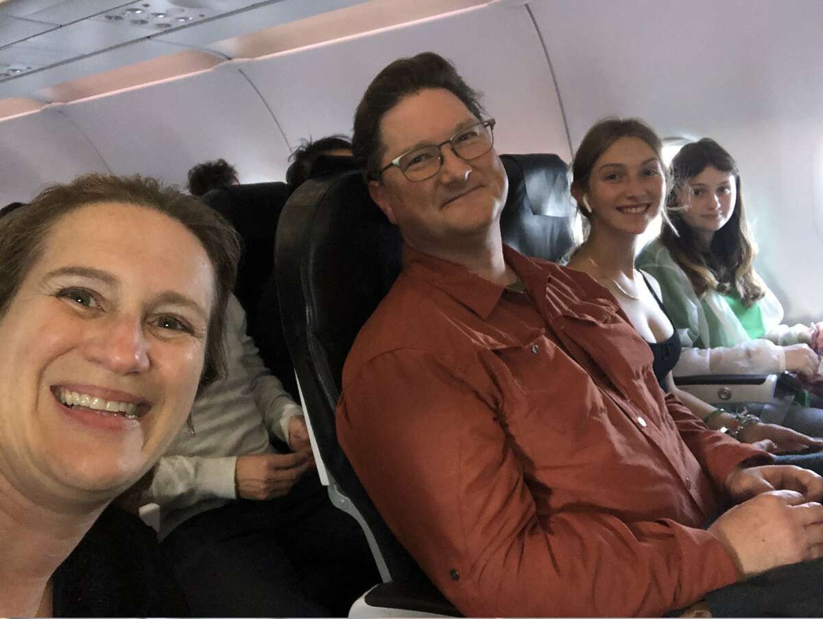 Former Alameda County forensic pathologist Judy Melinek taking a selfie with her husband T.J. Mitchell and two daughters on their flight to New Zealand.