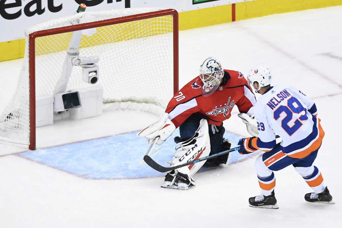 New York Islanders centre Brock Nelson (29) scores on Washington Capitals goaltender Braden Holtby (70) during the second period of an NHL Eastern Conference Stanley Cup hockey playoff game in Toronto, Friday, Aug. 14, 2020. (Nathan Denette/The Canadian Press via AP)