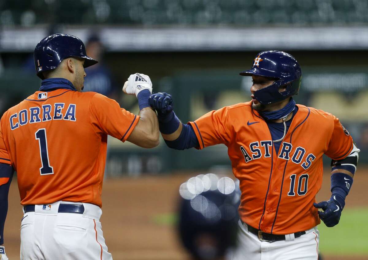 Houston Astros first baseman Yuli Gurriel (10) celebrates with shortstop Carlos Correa (1) after hitting a home run against the Seattle Mariners during the first inning of the MLB game at Minute Maid Park on Friday, Aug. 14, 2020, in Houston.