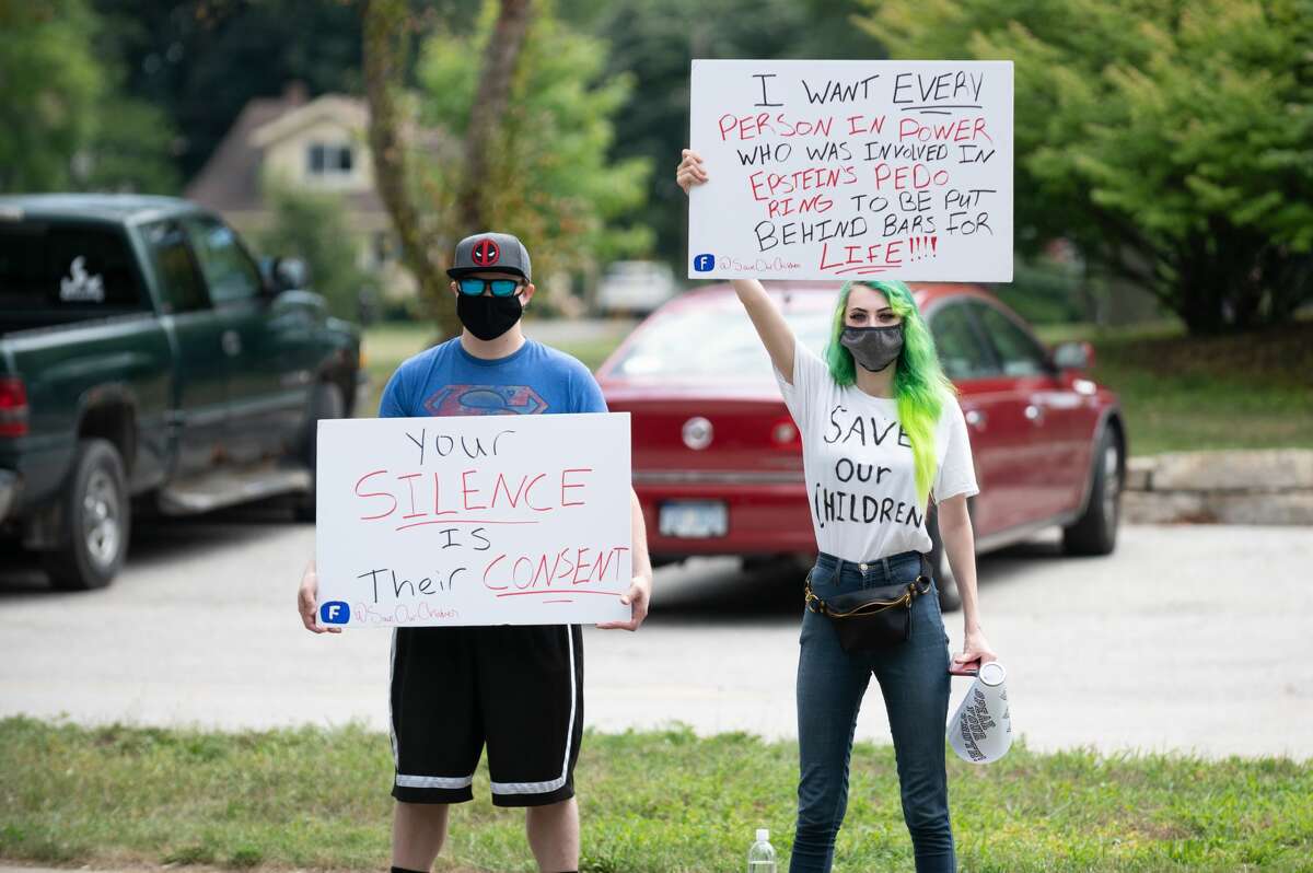 Dozens of people participate in a "Save Our Children" protest formed around downtown Midland Saturday, Aug. 15, 2020 to raise awareness of child abuse and human trafficking. (Adam Ferman/for the Daily News)