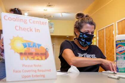Martinez Senior Community Center supervisor Gina Gravert checks residents into a cooling center.