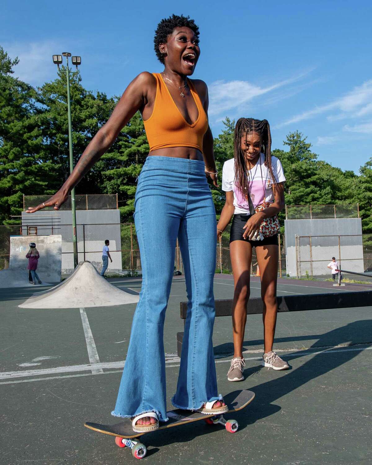 Destiny Harris gets a push from Chantelleigh Graham during a meet-up hosted by Noteworthy Resources to introduce women, youth, members of the LGBTQ+ community and their allies to the sport of skateboarding at the Albany Skate Park in Washington Park in Albany, NY, on Saturday, Aug. 15, 2020 (Jim Franco/special to the Times Union.)