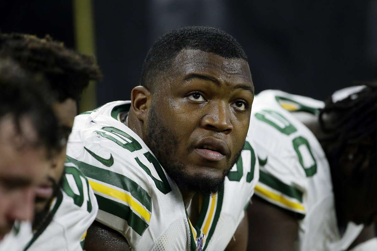 FILE - In this Dec. 29, 2019, file photo, Green Bay Packers nose tackle Kenny Clark (97) watches from the sideline during the second half of an NFL football game against the Detroit Lions in Detroit. Packers defensive tackle Kenny Clark admits he's surprised at how many players are passing on 2020. Although he is not considering it, he understands why the number of NFL opts outs surpasses the total for Major League Baseball, the NHL and NBA combined. (AP Photo/Duane Burleson, File)