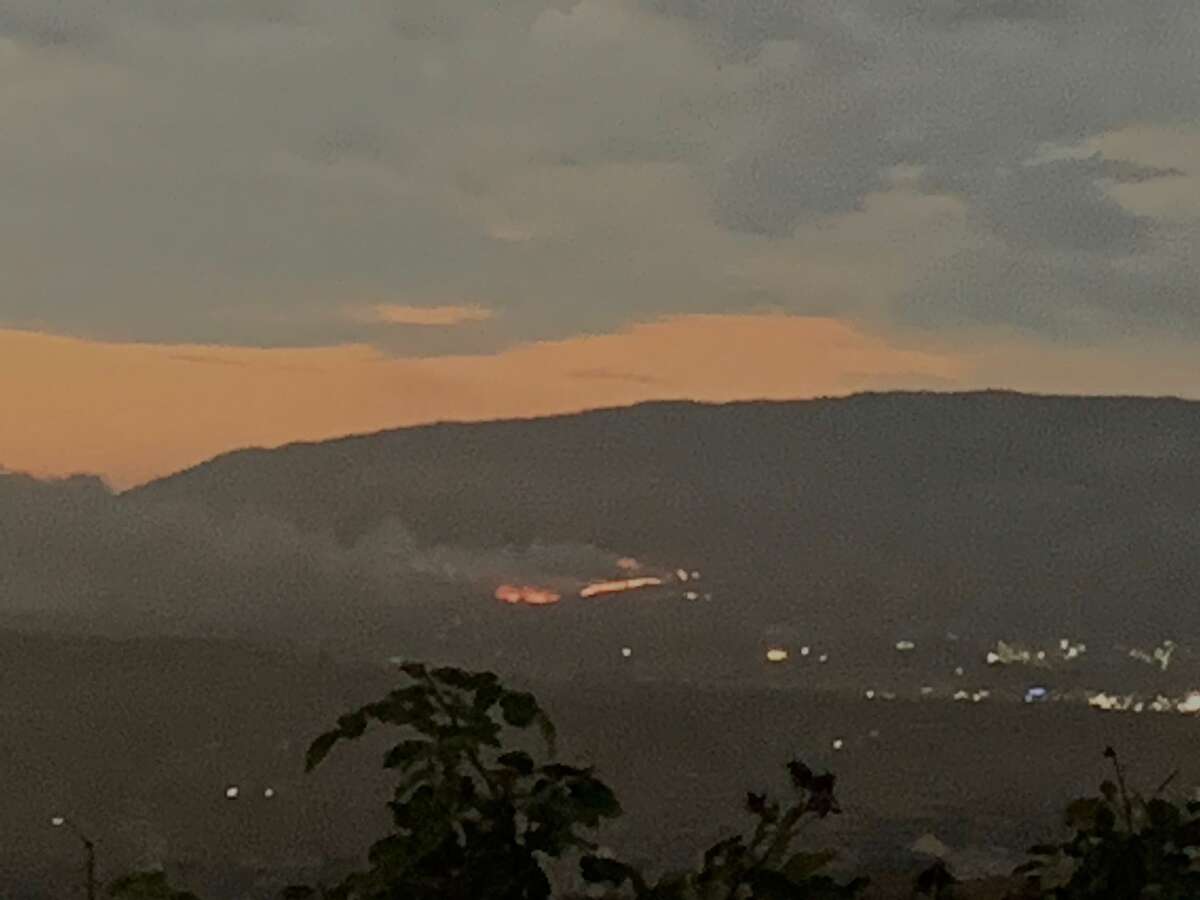 A brush fire is seen on the Pleasanton Ridge hills from San Ramon, California. Firefighters are on the scene.