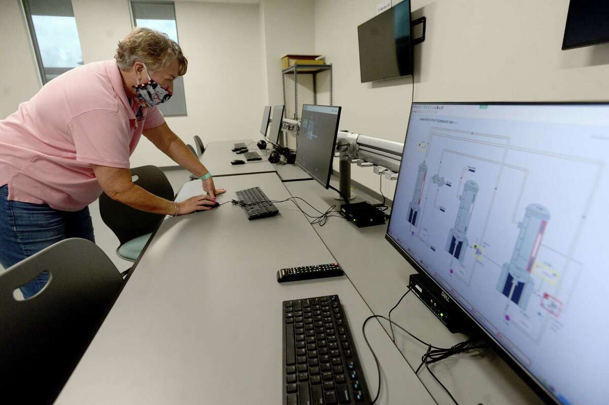 Instructor Valerie Worry sets up some of the process operating stations for students to look at.The computerized processing units have been recently upgraded and moved from the Cold Lab to the technology building at LIT. Photo taken Thursday, August 13, 2020 Kim Brent/The Enterprise