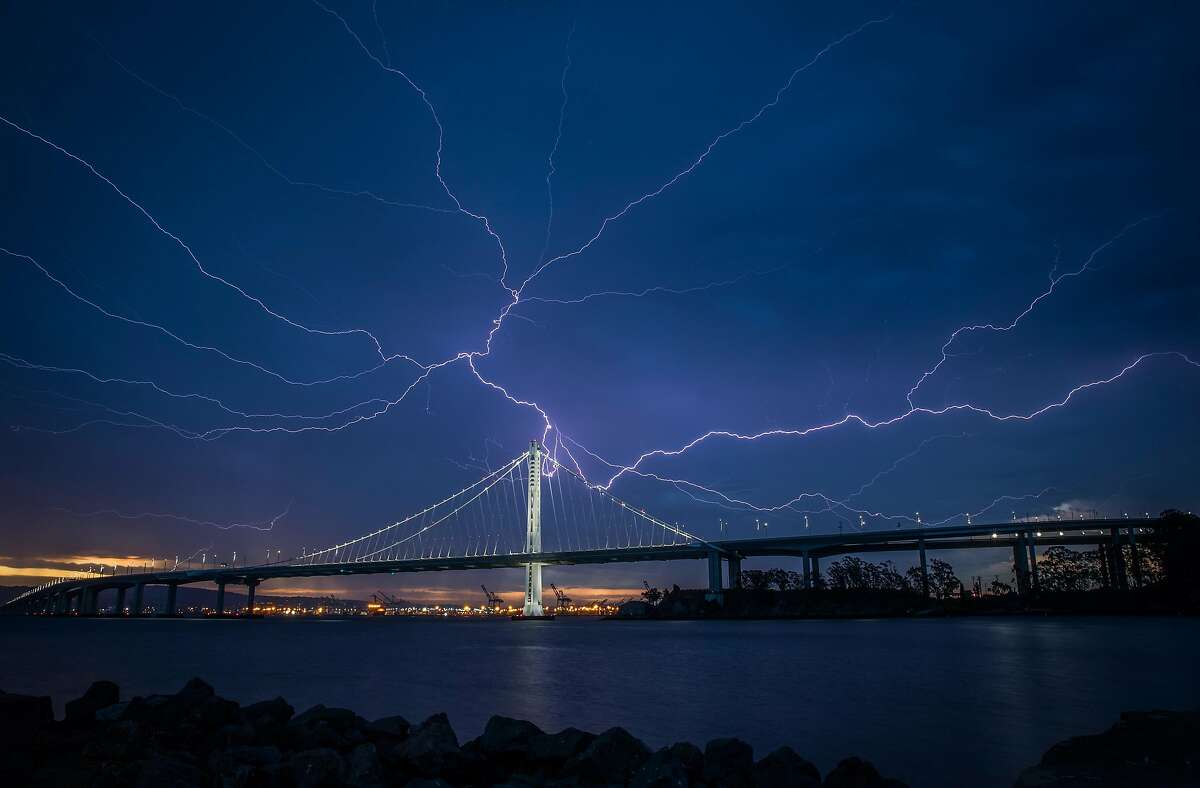 Lightning illuminates the sky over the eastern span of the Bay Bridge as a storm passed through the area on Sunday morning in San Francisco, Calif., on Sunday, August 16, 2020.