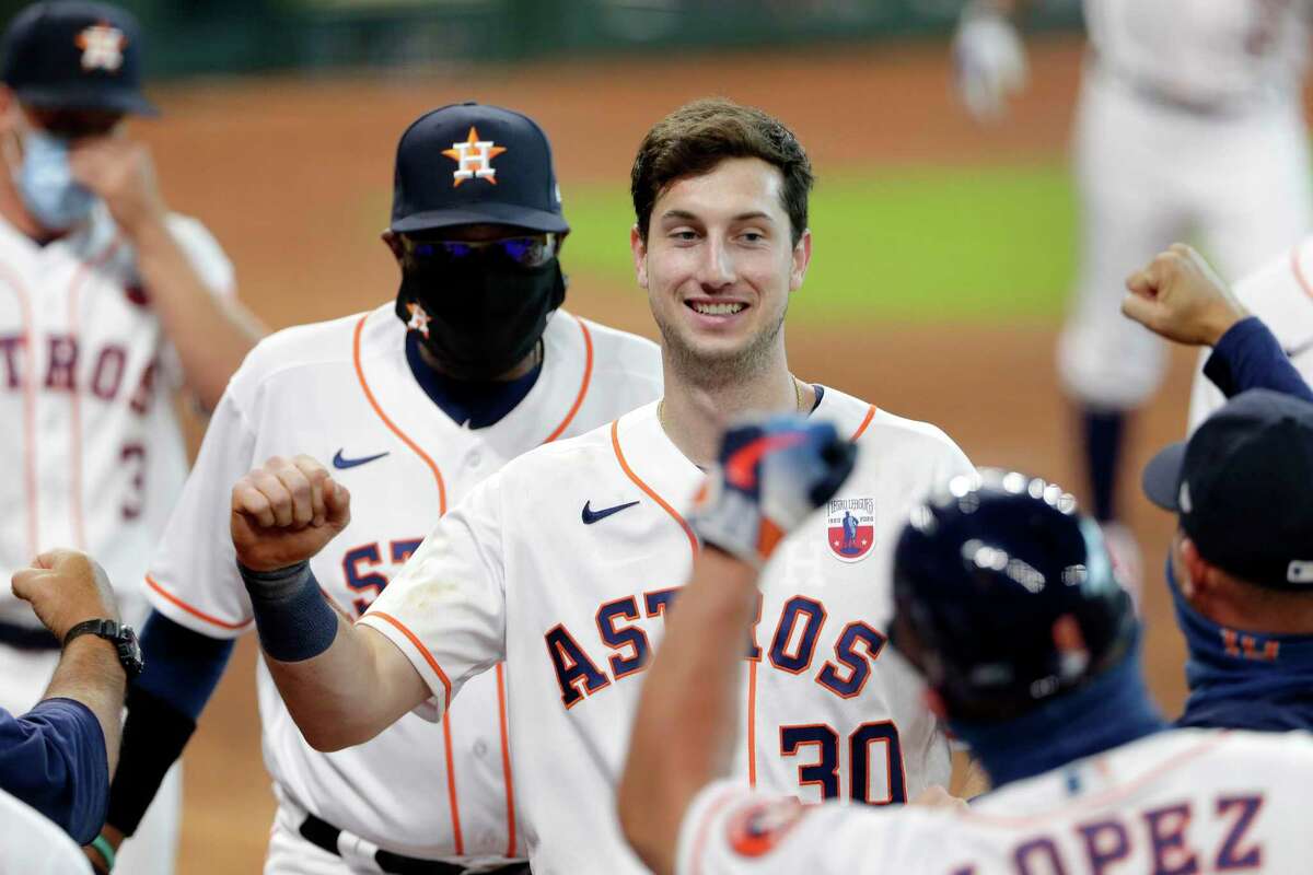 Houston Astros Kyle Tucker (30), is swarmed by teammates as he heads to the dugout after his walk-off home run in the ninth inning of a baseball game against the Seattle Mariners Sunday, Aug. 16, 2020, in Houston.