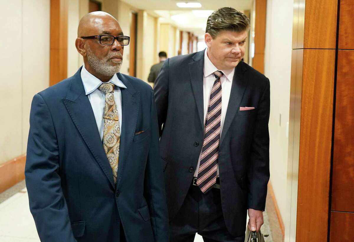 Otis Mallet, left, and his attorney Troy Locklear enter the 338th District Court Monday, Feb. 3, 2020, in Houston. District Judge Ramona Franklin declared Otis Mallet innocent of the 2008 drug charges that led to his conviction in 2011, after hearing arguments that the case was built on lies by former Houston police officer Gerald Goines.