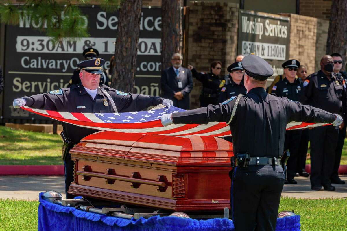 The flag that draped the casket of the fallen officer is removed to be folded so it can be presented to the family. On Saturday morning, the life of Officer Sheena Yarbrough-Powell was honored as she was laid to rest with a police escort from Broussard??s Mortuary to Calvary Baptist Church on Dowlen Road. Photo made on August 15, 2020. Fran Ruchalski/The Enterprise