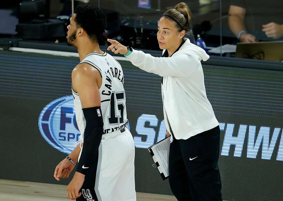 Spurs assistant coach Becky Hammon talks with Quinndary Weatherspoon #15 of the San Antonio Spurs during the third quarter against the Utah Jazz at HP Field House at ESPN Wide World Of Sports Complex on August 07, 2020 in Lake Buena Vista, Florida.
