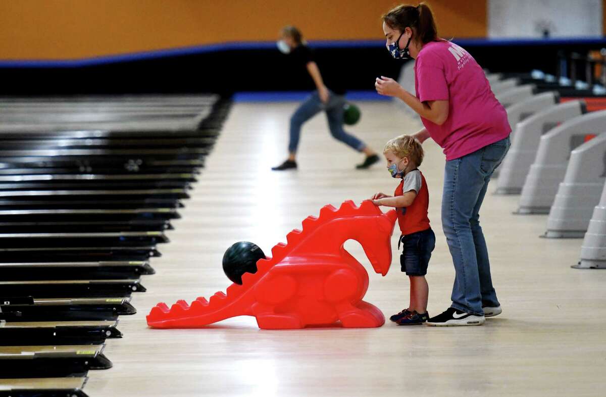 Samual Heil, 2, of Glens Falls gets a helping hand from his mother, Denise, during the first day of reopening for bowling centers under the state's coronavirus guidelines on Monday, Aug. 17, 2020, at Kingpin's Alley in South Glens Falls, N.Y. (Will Waldron/Times Union)