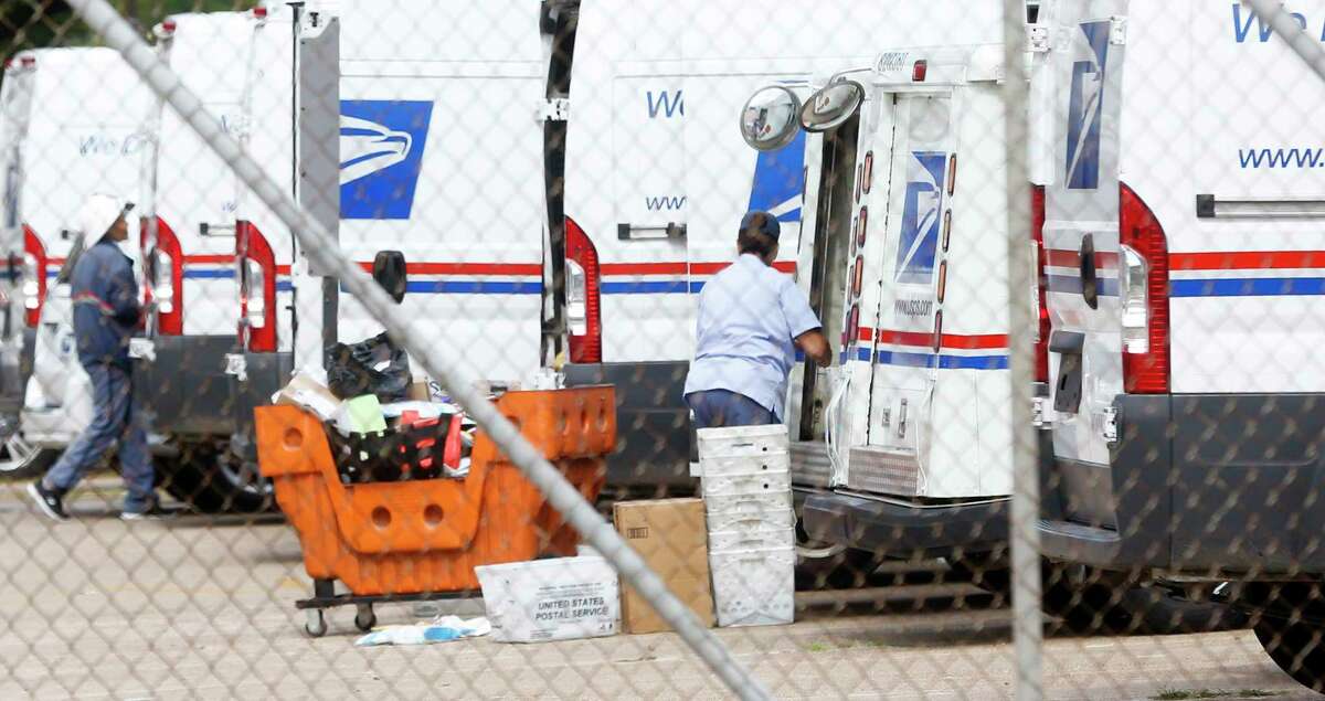 USPS employees load trucks at the Gray Street location in Houston on Monday, Aug. 17, 2020.