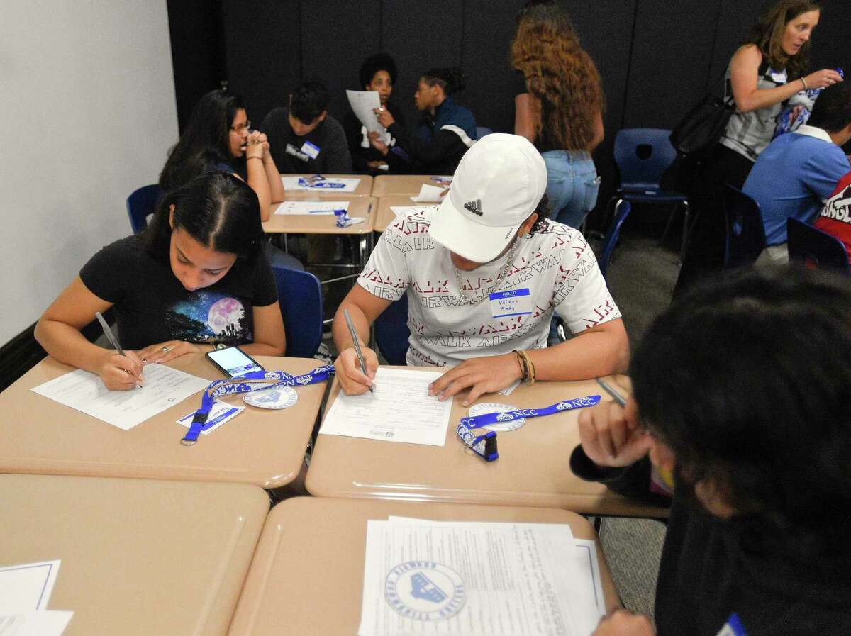Graduates of Stamford Public Schools fill out a college questionnaire during an event for the "Bridge to College" program at Stamford's Old Town Hall on June 20, 2019. Stamford Cradle to Career organized the event, which is working to address the gap between the number of Stamford Public School graduates,who say they're going to college and those who actually enroll.