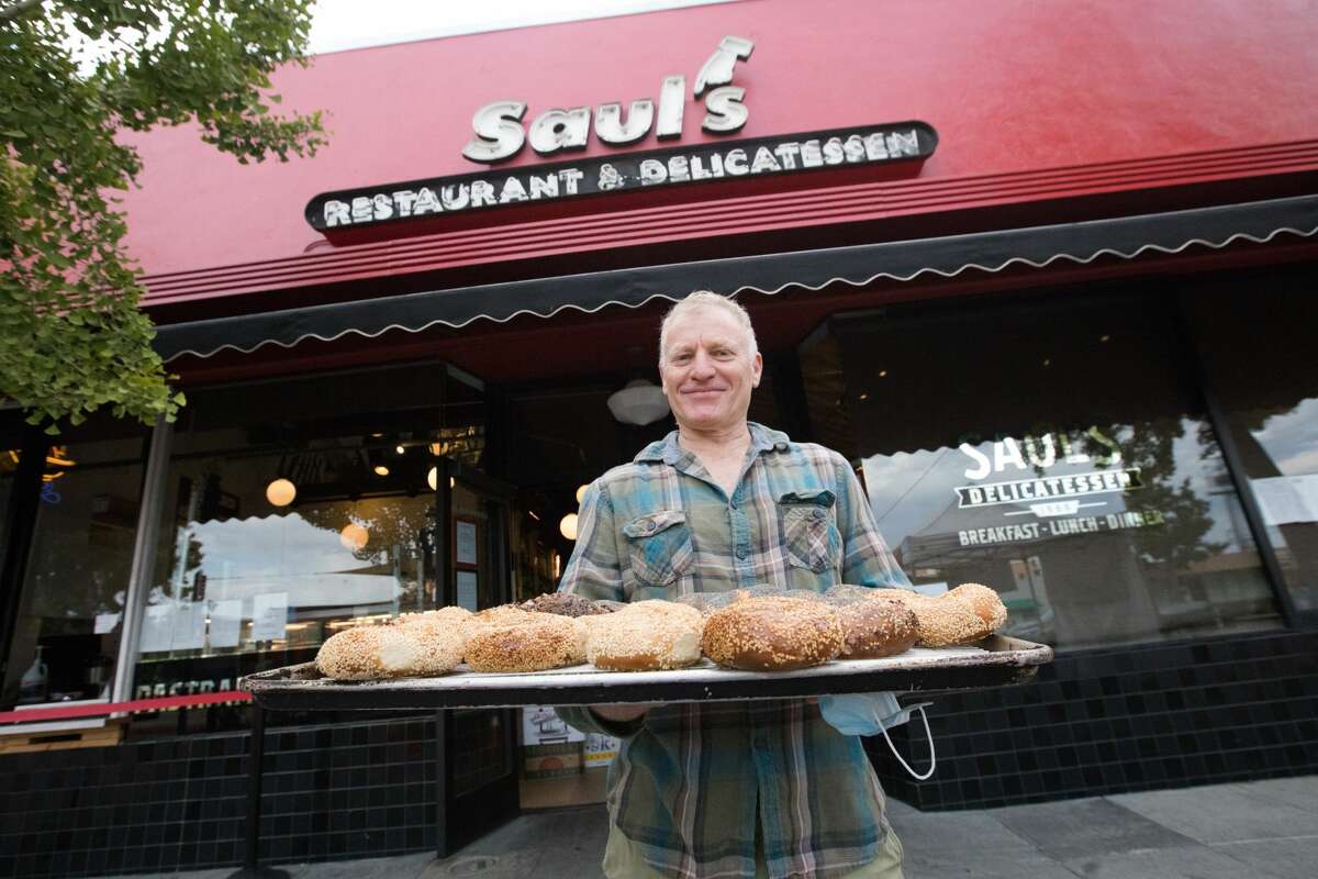 Owner Peter Levitt holds a tray of freshly baked bagels in front of Saul's Restaurant and Delicatessen in Berkeley on Aug. 11, 2020. Saul's Deli has new partners who will eventually become the new owners of the Bay Area institution. 