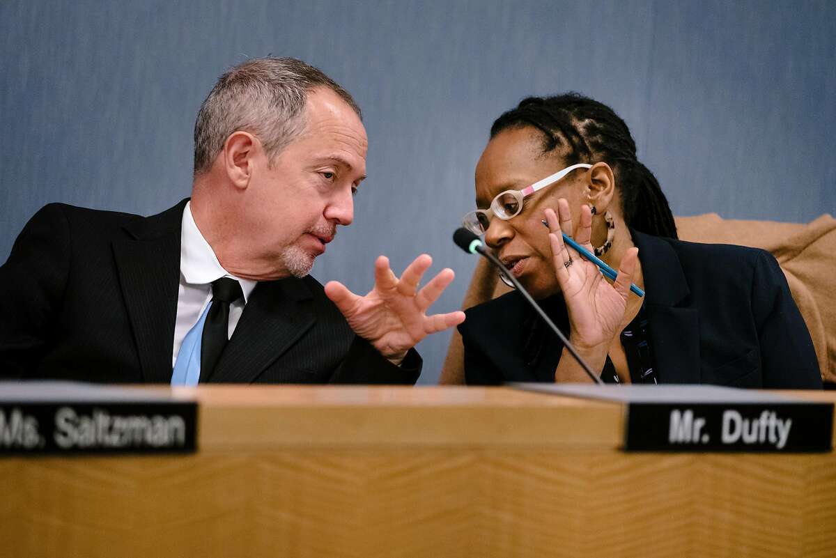 BART board of directors president Bevin Dufty, left, and district 7 director Lateefah Simon speak to each other during a BART meeting in Oakland, California, Monday, November 21, 2019.