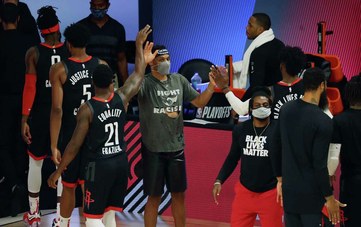 Houston Rockets point guard Russell Westbrook celebrates with teammates after the Rockets defeated the Oklahoma City Thunder in Game 1 of an NBA basketball first-round playoff series, Tuesday, Aug. 18, 2020, in Lake Buena Vista, Fla. (Kim Klement/Pool Photo via AP)