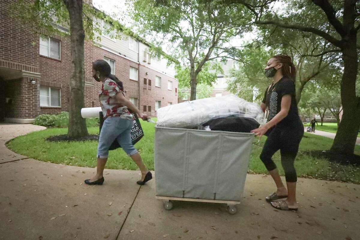 Rosalind Smith lead her freshman daughter Tamyah to her room at Prairie View A&M University Monday, Aug. 17, 2020, in Prairie View.