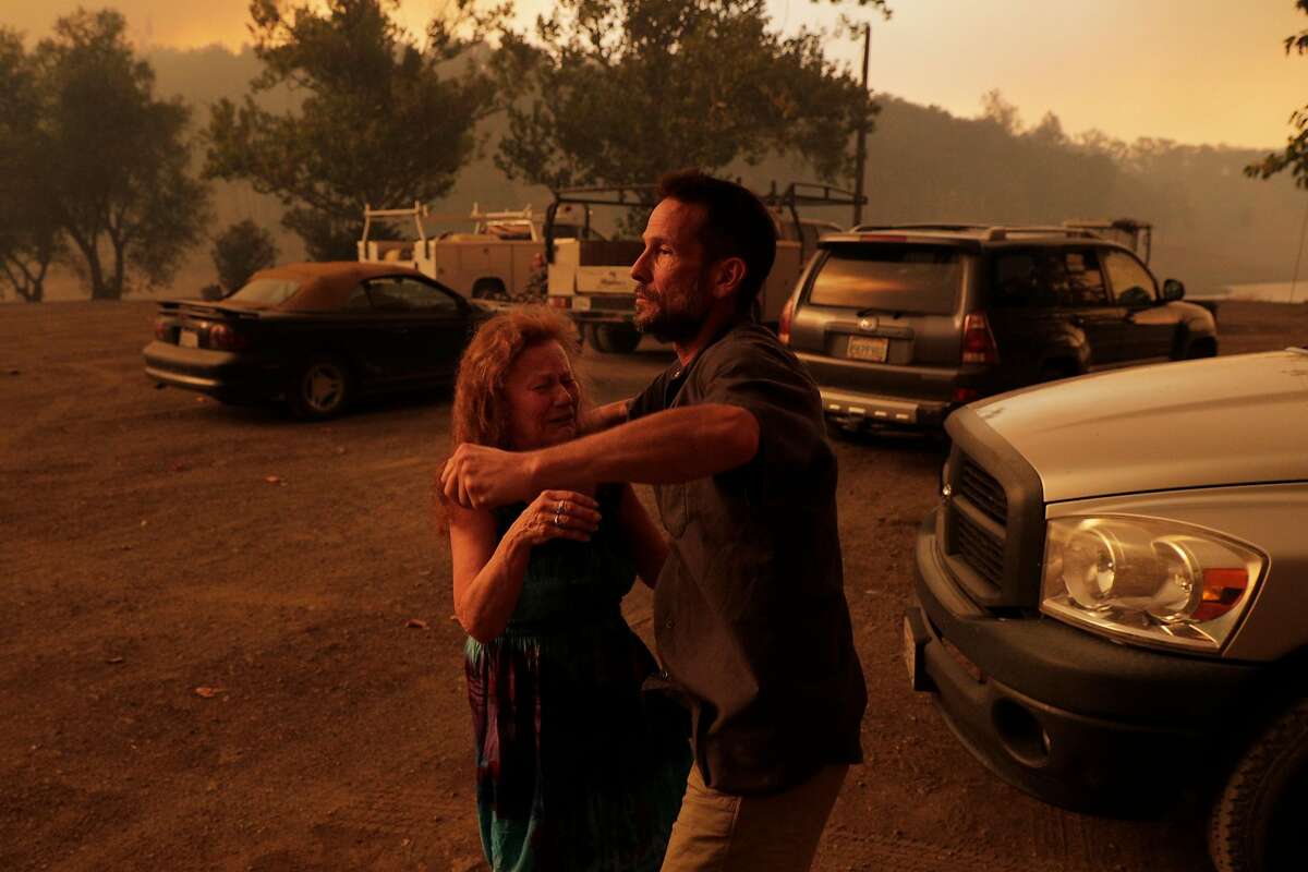 Peter Funkhouser comforts friend Judy Vollmer, who couldn’t find one of her cats before evacuating near Lake Berryessa.