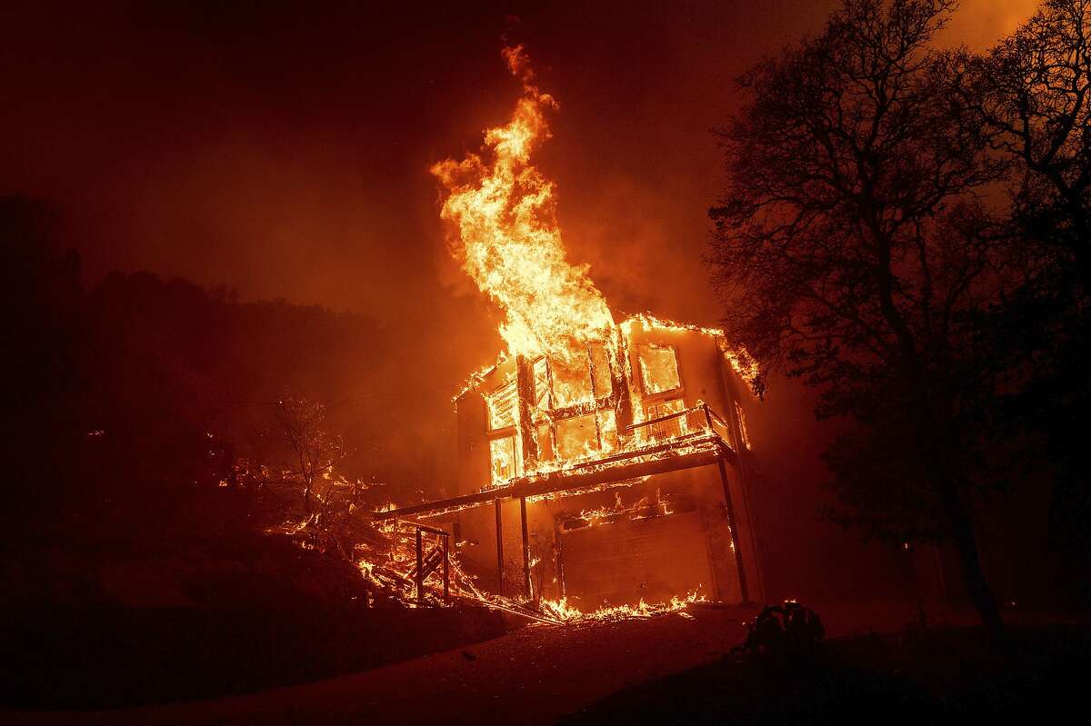 A home burns as the LNU Lightning Complex fires tear through the Spanish Flat community in unincorporated Napa County, Calif., Tuesday, Aug. 18, 2020. Fire crews across the region scrambled to contain dozens of wildfires sparked by lightning strikes as a statewide heat wave continues. (AP Photo/Noah Berger)